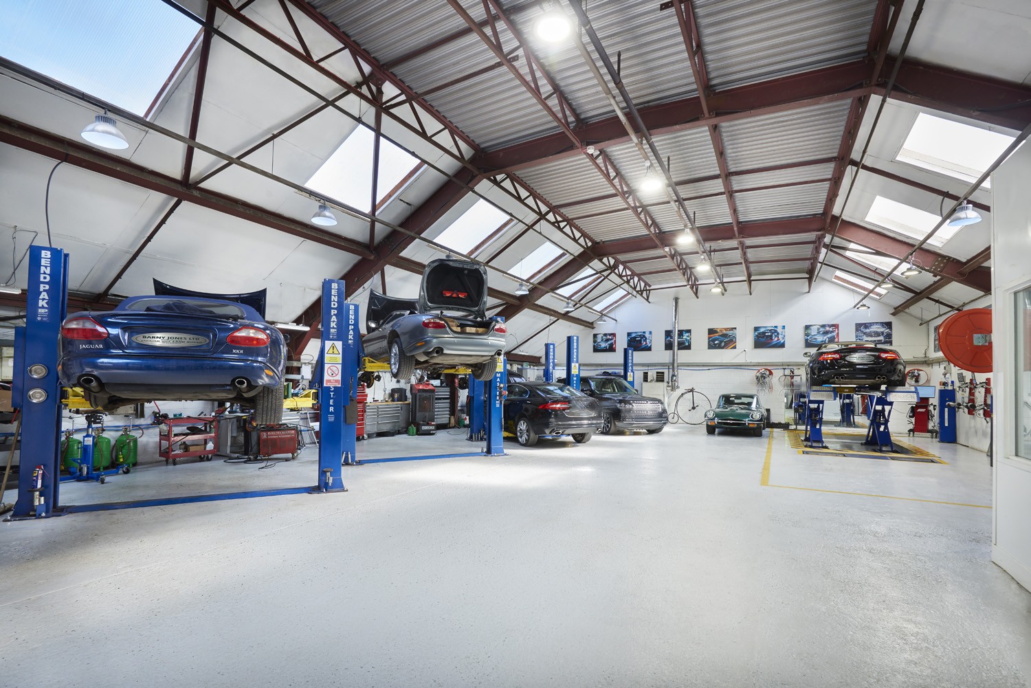 Inside the Barny Jones workshop: cars on the lifts and the E-Type at the back